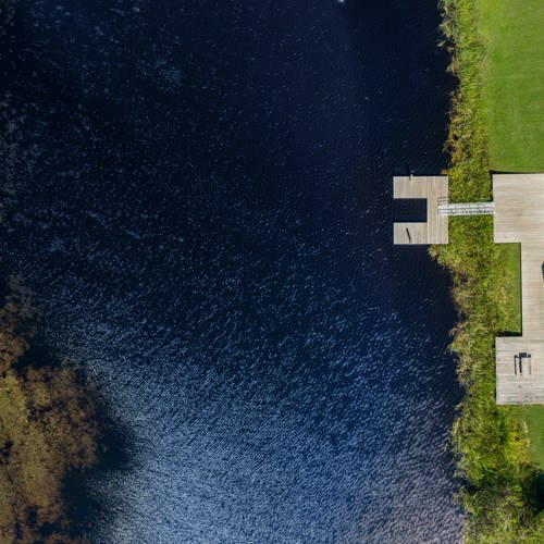 Ariel view of pavilion and lake access with dock